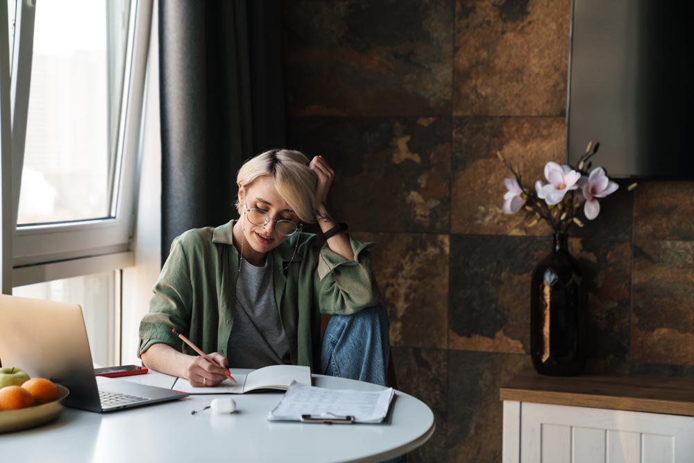 Middle aged blonde woman with short hair studying